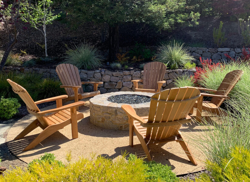 five Adirondack chairs around a fire pit in a peaceful patio area Paradise Teak Bay Area California