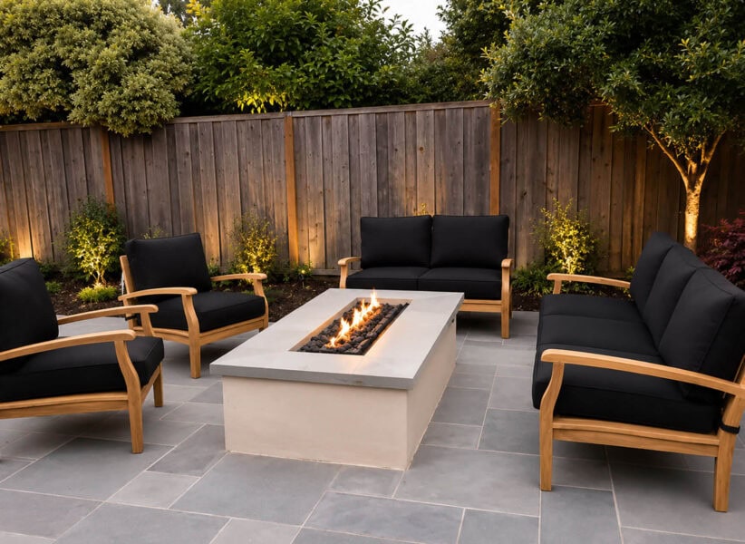 outdoor space with modern fire pit and teak chairs and love seat with black cushions from Paradise Teak Bay Area California