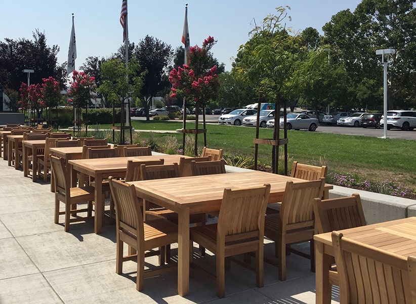 well made teak dining tables and chairs at a resort's outdoor patio Paradise Teak Bay Area California