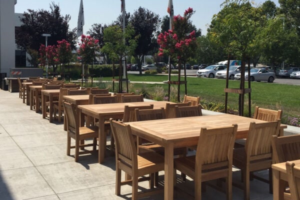 teak dining tables and chairs used commercially at a resort's outdoor patio Paradise Teak Bay Area California